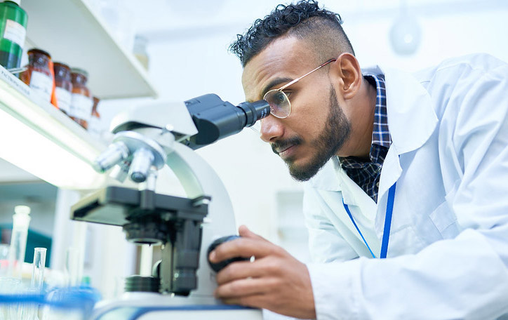 student looking through microscope