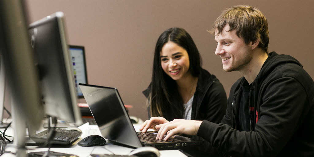 male and female students work on a computer together