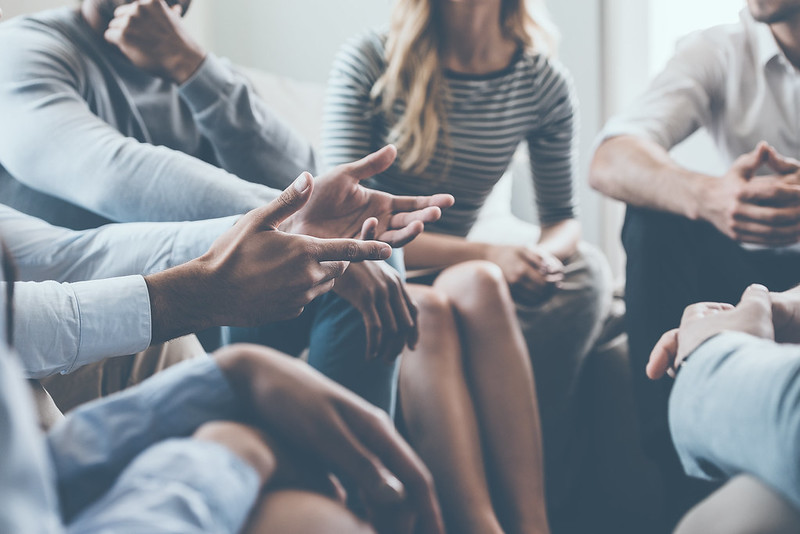 diverse group of people talking in a circle