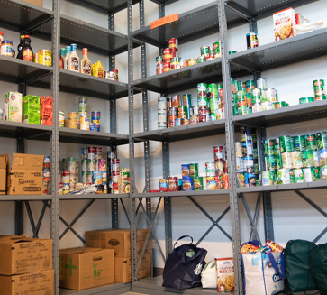 Campus Cupboard photo with can goods on shelves