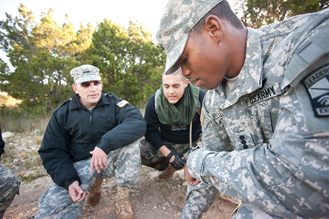 U.S. Army soldiers gather in a circle to solve a problem