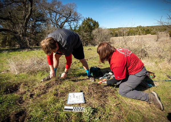 Two students work on a unit outside of the Priddy Cabin