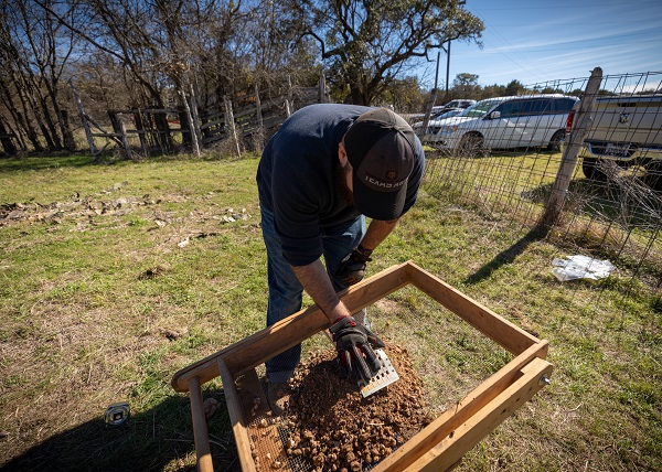 Student Joshua Lip screentesting dirt from his unit