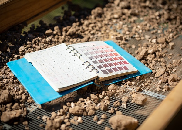 A Munsell soil book sits on a sifter