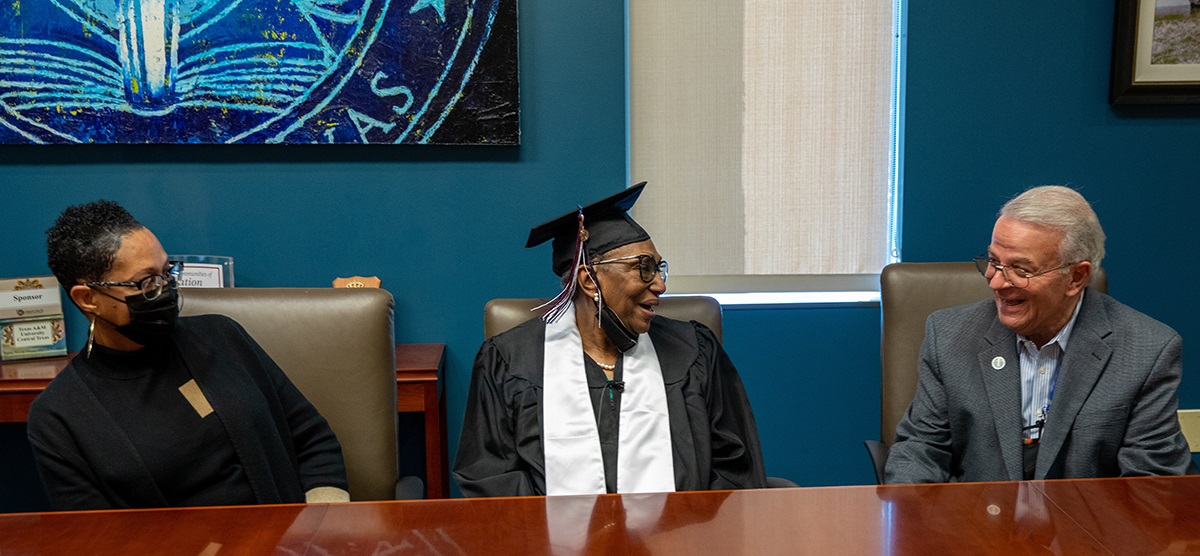 Ethel Johnson (center) and her daughter, Theresa Johnson (left), speak with President Marc Nigliazzo (right)