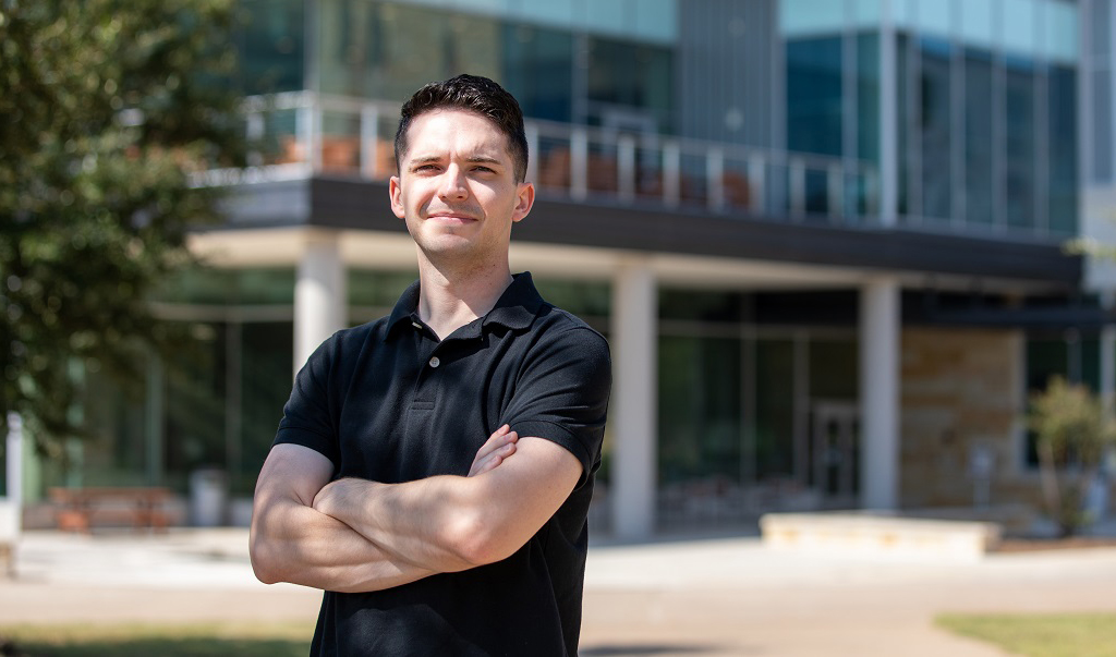 Thomas Reid stands in front of Warrior Hall