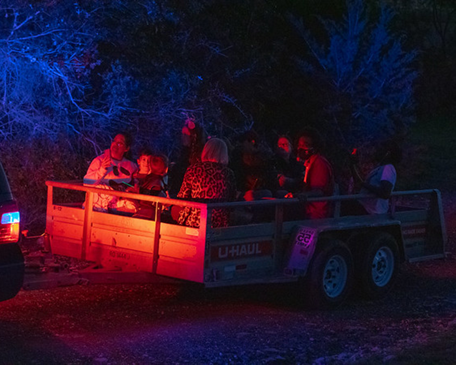 A police SUV hauls a trailer onto the haunted hayride path.