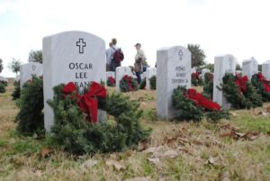 wreaths in front of headstones