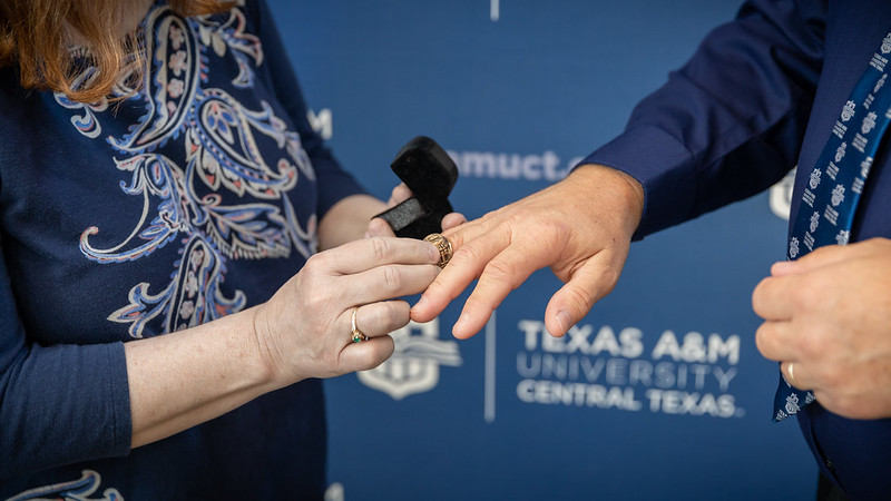 A Class Ring is slipped onto the recipient's finger