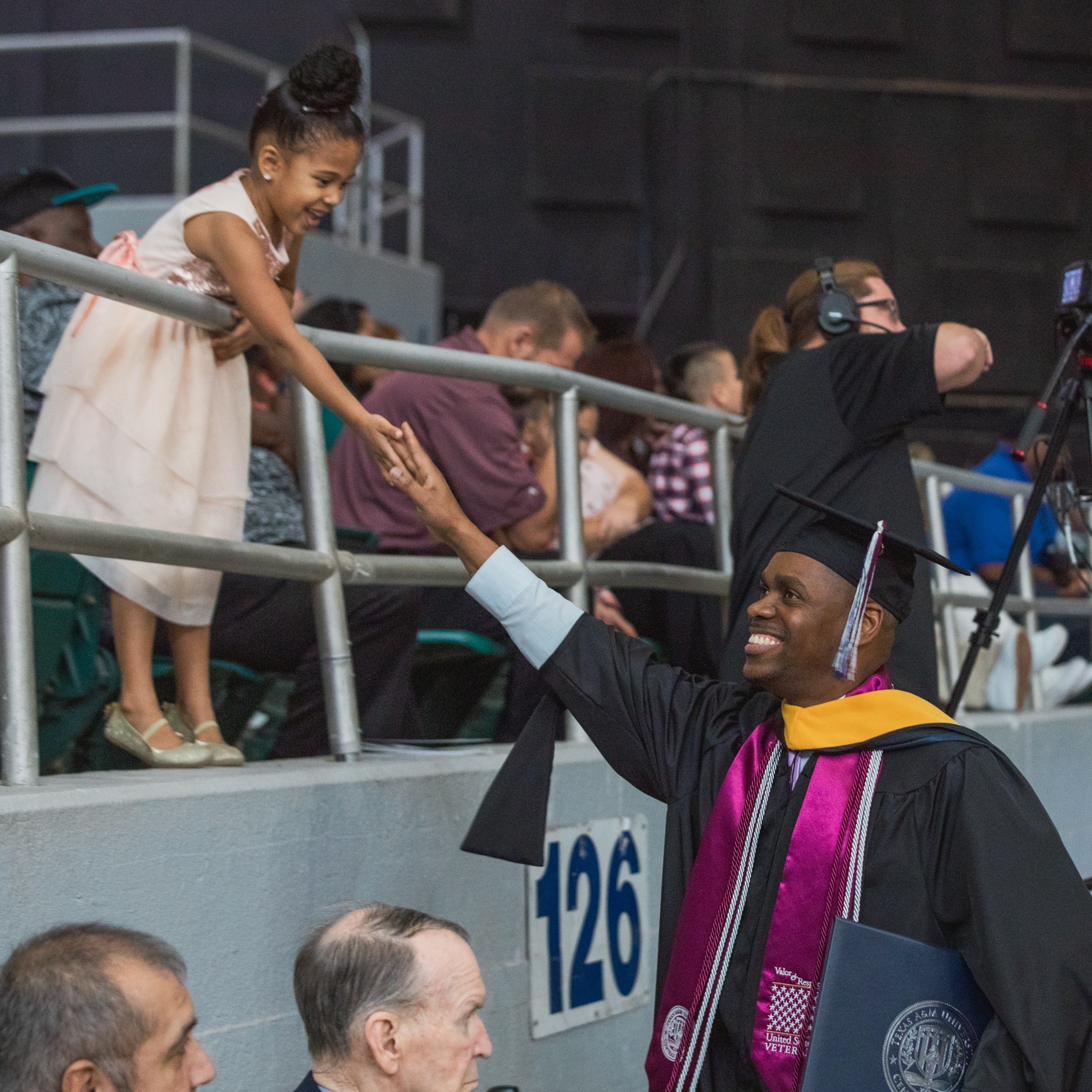 Frantzy Mesadieu and his daughter, Bernadette, celebrate during graduation.