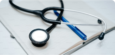 A stethoscope and blue pen resting on top of an empty notebook