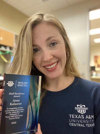 Anna Kefauver holding her TAMUCT Staff Excellence Award 