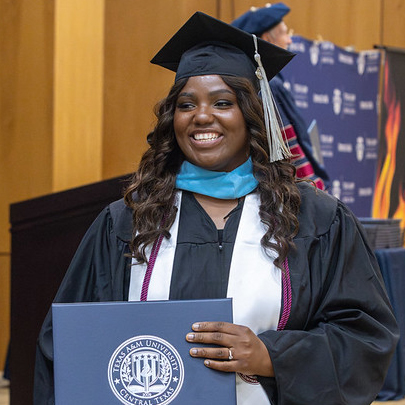 Masters graduate student holding diploma