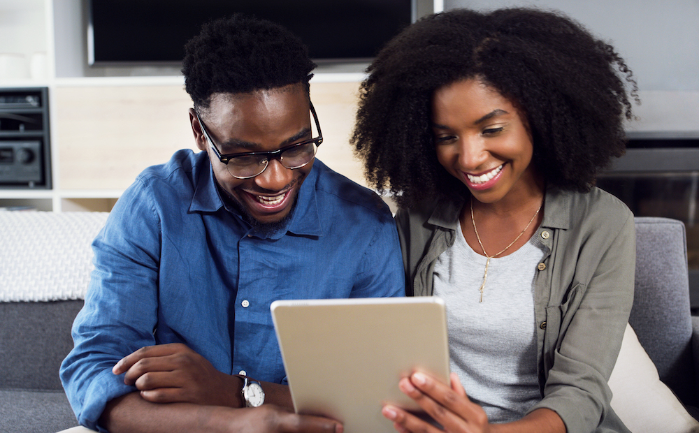 Shot of a cheerful  young couple using a digital tablet together at home