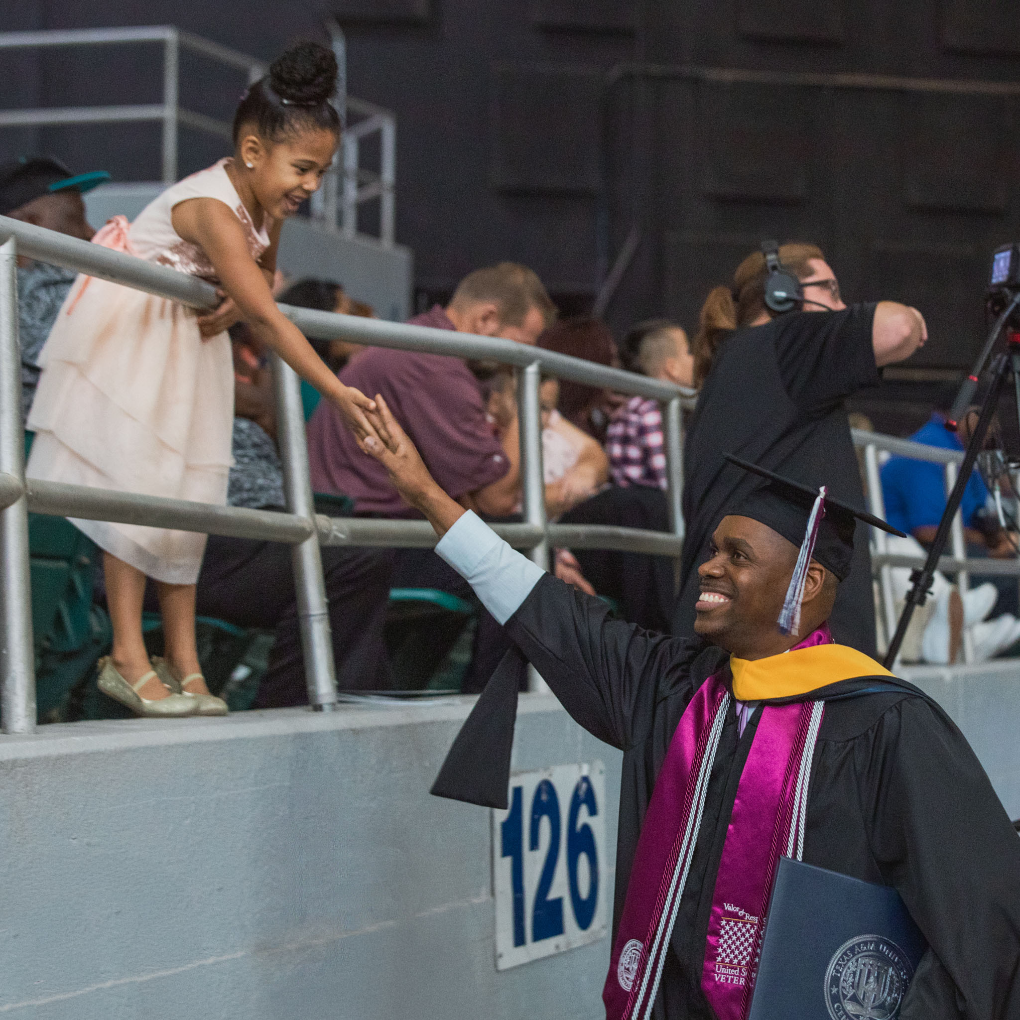 Frantzy Mesadieu and his daughter, Bernadette, celebrate during graduation.