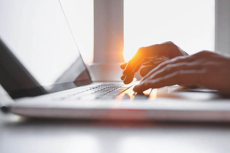 A person typing on a laptop