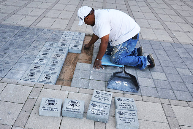Worker installing paver