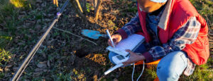 Anthropology, BS - Young woman performing pH test on the field.