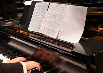 Close up of a piano with sheet music