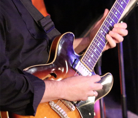 A student plays a guitar