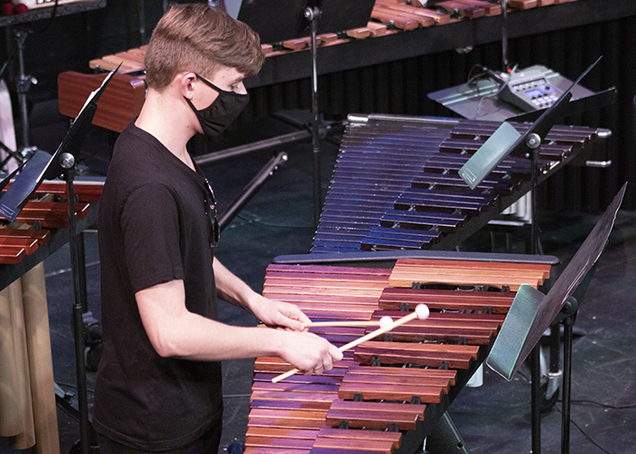 A member of the percussion ensemble at his instrument