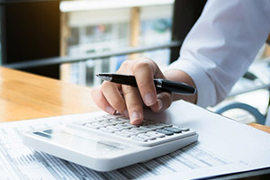 A person inputting numbers into a calculator