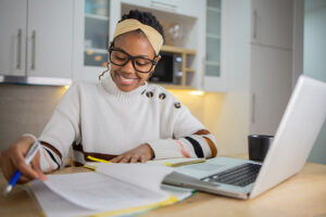 Grad School ROI image of Young businesswoman working from home