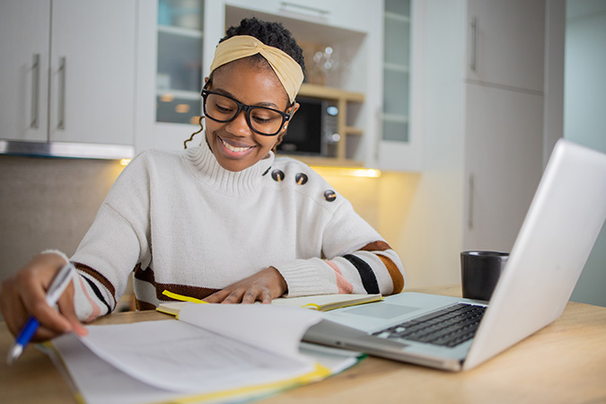 Grad School ROI image of Young businesswoman working from home