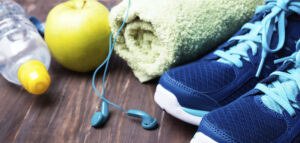 Workout shoes, towel, apple