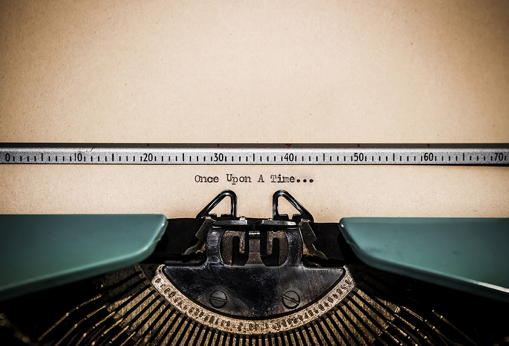 The words 'Once Upon A Time...' picked out on a grungy old typewriter. Macro image with limited depth of field focussed on 'on' in 'upon'.