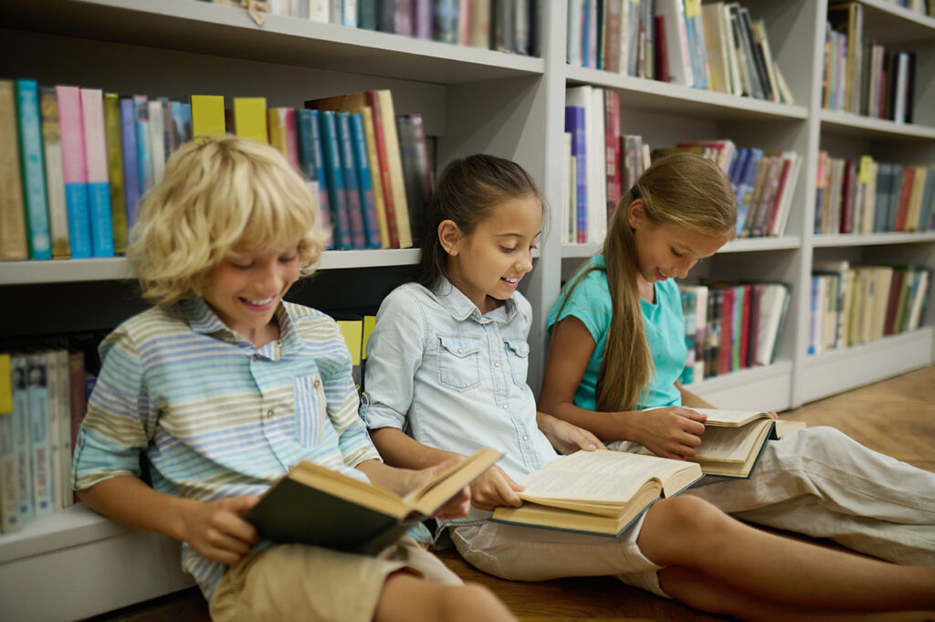 Children sitting in Library looking at books