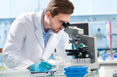 Photo of biology scientist looking into microscope