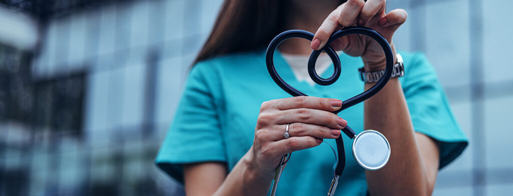 Nurse holding stethoscope in shape of heart