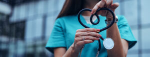 Nurse holding stethoscope in shape of heart