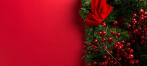 Photo of a festival holiday background with red wrapping paper and pine