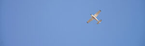 Photograph of training aircraft flying against a blue sky.