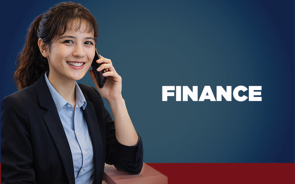 Dark haired woman in a business suit talking on a cell phone.