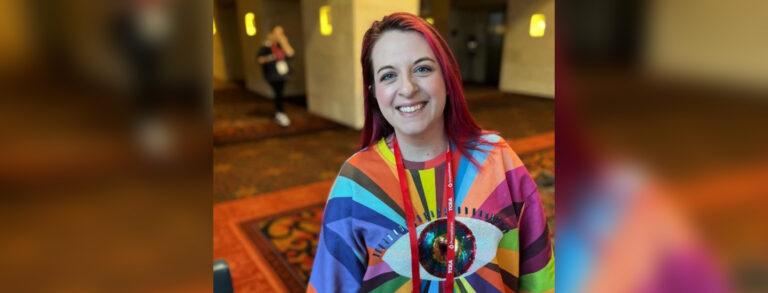 Long-haired woman in tie-dyed shirt.