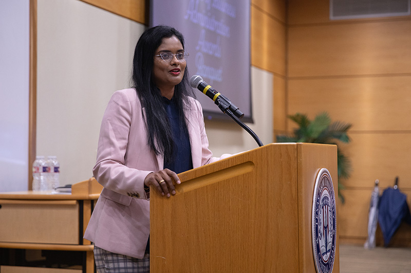 Woman speaking at a podium.