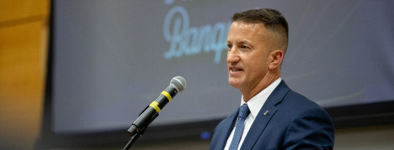 Man speaking into a microphone.