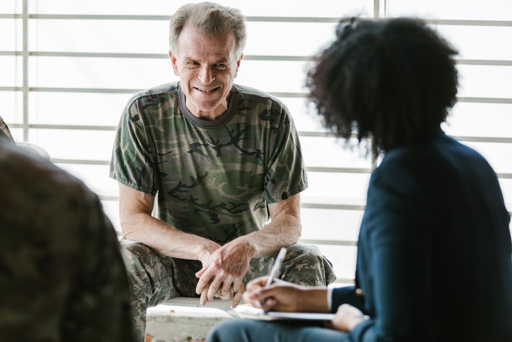 A military veteran engaging in a supportive advising session, focusing on education.