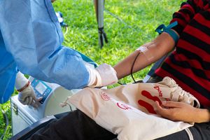 A person donating blood outdoors in Piura, Peru, emphasizing life-saving charity.